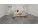Large, carpeted bedroom with two windows and neutral decor at 487 Thistledown Way, The Villages, FL 32162