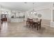 Open-concept dining room view into kitchen and living spaces at 487 Thistledown Way, The Villages, FL 32162