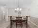 Dining room features decorative rug, chandelier, and seating for four at 487 Thistledown Way, The Villages, FL 32162