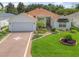 Charming single-story home with a well-manicured lawn and inviting curb appeal at 487 Thistledown Way, The Villages, FL 32162