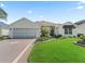 Well-maintained home with decorative driveway and manicured front yard at 487 Thistledown Way, The Villages, FL 32162