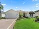 Single-Gathering home with landscaped front yard and decorative driveway at 487 Thistledown Way, The Villages, FL 32162