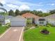 Well-maintained home boasts a lush lawn and meticulous landscaping, enhancing its curb appeal at 487 Thistledown Way, The Villages, FL 32162