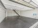 Spacious garage with epoxy floors and attic access provides ample storage space at 487 Thistledown Way, The Villages, FL 32162