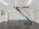 Epoxy floor garage with attic access and pull-down ladder for storage at 487 Thistledown Way, The Villages, FL 32162