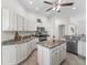 Modern kitchen with granite countertops, stainless steel appliances, and central island at 487 Thistledown Way, The Villages, FL 32162