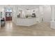 Open-concept kitchen features white cabinets, granite countertops, and stainless steel appliances at 487 Thistledown Way, The Villages, FL 32162