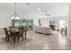 Spacious living room with high ceilings, tile floors, and sliding glass doors to the backyard at 487 Thistledown Way, The Villages, FL 32162