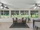 Sun room with tile flooring, view of green backyard at 487 Thistledown Way, The Villages, FL 32162