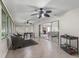 Bright sun room with tile floor and multiple seating areas at 487 Thistledown Way, The Villages, FL 32162
