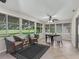 Sun room with tile flooring and view of well manicured yard at 487 Thistledown Way, The Villages, FL 32162