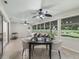 Bright sunroom with tile floors, multiple ceiling fans and scenic backyard views at 487 Thistledown Way, The Villages, FL 32162