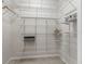 Organized walk-in closet with white wire shelving and tile floor at 487 Thistledown Way, The Villages, FL 32162