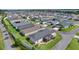 Aerial view of home featuring screened lanai, manicured landscaping, modern driveway, and community at 4874 Noreen Ct, The Villages, FL 32163
