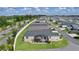 Overhead view of home featuring screened lanai, manicured landscaping and modern driveway at 4874 Noreen Ct, The Villages, FL 32163