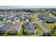Overhead view of neighborhood with home featuring screened lanai, manicured landscaping and modern driveway at 4874 Noreen Ct, The Villages, FL 32163