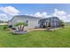 This home has a well-maintained backyard, a screen-in patio, and beautiful, tropical landscaping at 4874 Noreen Ct, The Villages, FL 32163