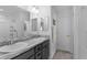 Bathroom features double sinks with granite countertops and a large mirror at 4874 Noreen Ct, The Villages, FL 32163