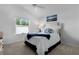Cozy bedroom featuring a comfortable bed and window with natural light at 4874 Noreen Ct, The Villages, FL 32163