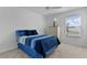 Comfortable bedroom features a large window, ceiling fan, and neutral colors at 4874 Noreen Ct, The Villages, FL 32163