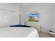 Bright bedroom featuring dresser with TV and closet doors on carpet at 4874 Noreen Ct, The Villages, FL 32163