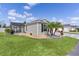 Charming single-Gathering home featuring a screened lanai, well-maintained lawn and tropical landscaping at 4874 Noreen Ct, The Villages, FL 32163