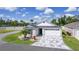 Charming single-Gathering home featuring a three-car garage and a meticulously designed front yard with palm tree at 4874 Noreen Ct, The Villages, FL 32163