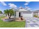 Charming one-story home features a well-manicured lawn and a beautifully designed driveway at 4874 Noreen Ct, The Villages, FL 32163