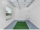The two car garage features painted floor and walls, wash tub and bright lighting at 4874 Noreen Ct, The Villages, FL 32163