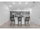 Eat-in kitchen featuring stainless appliances, grey cabinets, a tile backsplash, and modern counter seating at 4874 Noreen Ct, The Villages, FL 32163