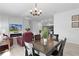 Open-concept layout seamlessly connecting the dining and living areas, filled with natural light at 4874 Noreen Ct, The Villages, FL 32163