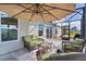 Screened patio features wicker furniture, ceiling fan, and outdoor living space at 4874 Noreen Ct, The Villages, FL 32163