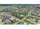 Stunning aerial view of a community with a pool, golf course, and lush landscaping at 516 Junction Pl, The Villages, FL 32163