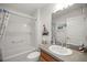 Bathroom featuring a shower-tub combo, tile flooring, single sink vanity, and neutral walls at 516 Junction Pl, The Villages, FL 32163