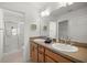 Spacious bathroom featuring a double sink vanity, a large framed mirror, updated cabinets, and walk-in shower at 516 Junction Pl, The Villages, FL 32163
