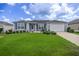 Charming single-story home with well-maintained lawn, tidy landscaping, and inviting curb appeal at 516 Junction Pl, The Villages, FL 32163