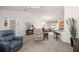 Bright living room with lots of natural light, neutral carpet, and open layout at 516 Junction Pl, The Villages, FL 32163