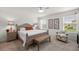 Bright main bedroom features neutral walls, chair rail, ceiling fan, area rug, and an abundance of natural light at 516 Junction Pl, The Villages, FL 32163