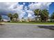 A trellised walkway is seen in the neighborhood recreation area, with mature palm trees in the background at 516 Junction Pl, The Villages, FL 32163