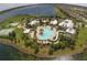 Aerial view of community pool, lake, and meticulously manicured landscaping at 520 Rainbow Springs Loop, Groveland, FL 34736
