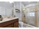 Bathroom features a glass-enclosed shower, vanity with ample counter space and tile flooring at 520 Rainbow Springs Loop, Groveland, FL 34736