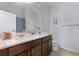 Bathroom features a well-lit mirror, vanity with ample counter space, and modern fixtures at 520 Rainbow Springs Loop, Groveland, FL 34736