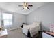 Cozy bedroom features a comfortable bed, soft carpet, and bright natural light at 520 Rainbow Springs Loop, Groveland, FL 34736
