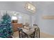 Open dining area with a table set for four and decorative chandelier at 520 Rainbow Springs Loop, Groveland, FL 34736
