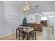 Dining area with direct views into the living area and television at 520 Rainbow Springs Loop, Groveland, FL 34736