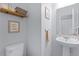 Stylish half bathroom featuring a pedestal sink and modern decor at 520 Rainbow Springs Loop, Groveland, FL 34736