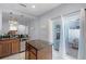 Bright kitchen featuring a kitchen island with granite countertop and sliding doors at 520 Rainbow Springs Loop, Groveland, FL 34736