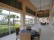 Enclosed lounge with tables and chairs overlooking the pool and grounds at 520 Rainbow Springs Loop, Groveland, FL 34736
