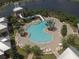 Community pool features palm trees, lounge chairs, and a water slide at 520 Rainbow Springs Loop, Groveland, FL 34736