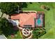 Overhead shot of the property showcasing a large pool, lush landscaping, and tile roof at 5235 Greens Dr, Lady Lake, FL 32159